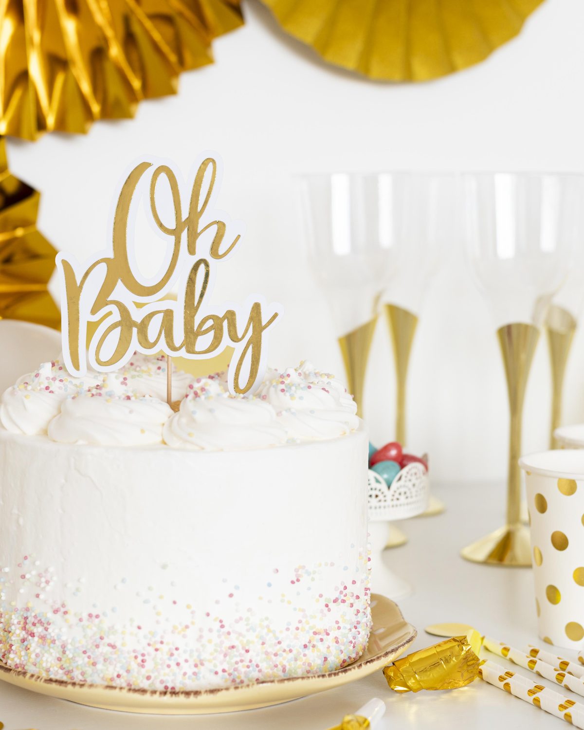 Gold party decoration with cake topper and celebration styling