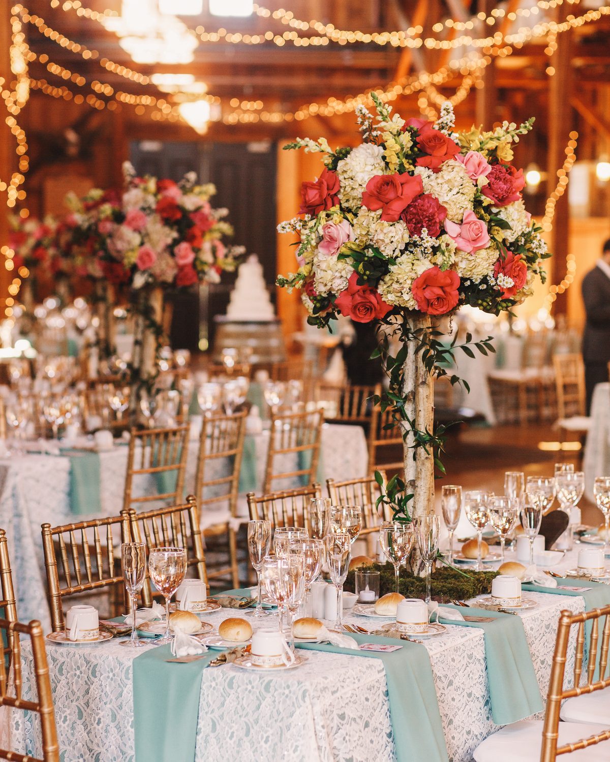 Wedding reception tables with floral centerpieces and string lights